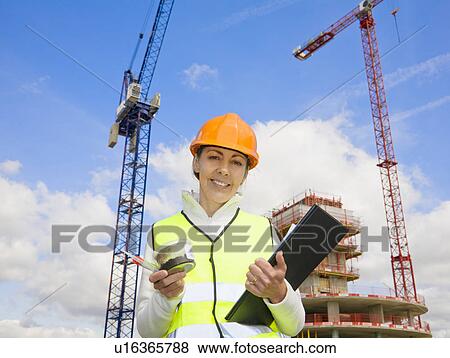 Woman viewing sample at building site View Large Photo Image Stock Photo - Woman viewing sample at building site. Fotosearch