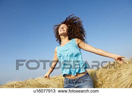 Woman walking in a wheat field View Large Photo Image Stock Image - Woman walking in a wheat field. Fotosearch