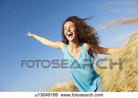 Woman walking in a wheat field View Large Photo Image Stock Photo - Woman walking in a wheat field. Fotosearch