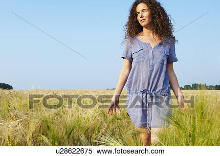 Woman walking in a wheat field View Large Photo Image Stock Photography - Woman walking in a wheat field. Fotosearch