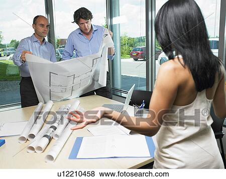 Stock Photo - Woman with architects and blue prints. Fotosearch