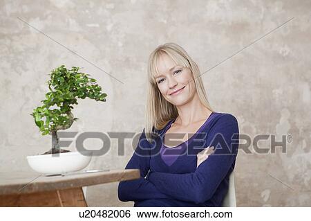 Stock Photograph - woman with bonsai. Fotosearch