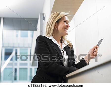 Woman with credit card at front desk View Large Photo Image Stock Image - Woman with credit card at front desk. Fotosearch