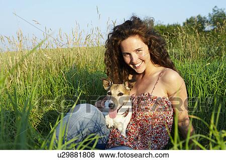 Woman with dog, in a wheat field View Large Photo Image Stock Photo - Woman with dog, in a wheat field. Fotosearch