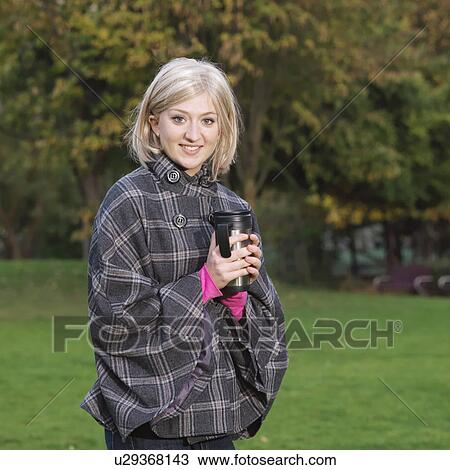 Stock Image - woman with flask outside. Fotosearch
