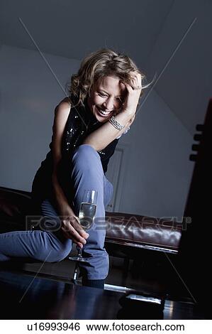 woman with glass of champagne smiling View Large Photo Image Stock Photograph - woman with glass of champagne smiling. Fotosearch