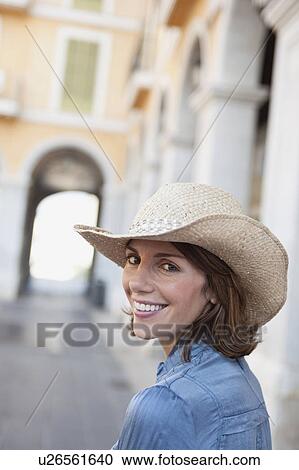 Stock Image - woman with hat looking at viewer. Fotosearch