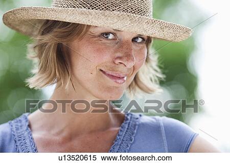 Stock Photography - woman with hat looking at viewer. Fotosearch
