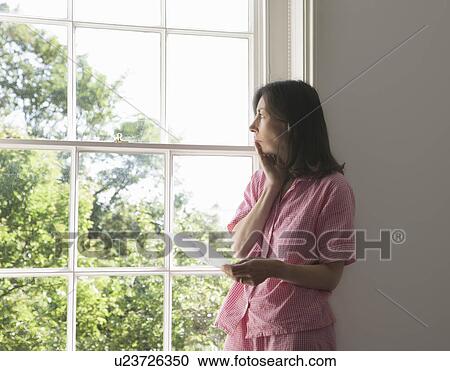Woman with letter by window View Large Photo Image Stock Image - Woman with letter by window. Fotosearch