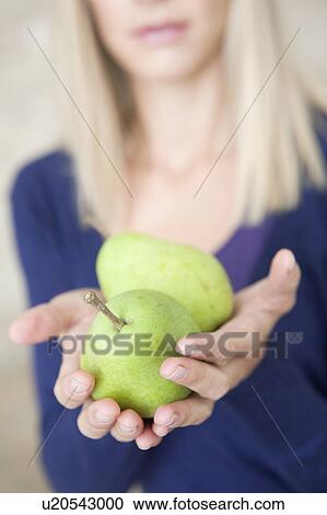 Stock Image - woman with pears. Fotosearch