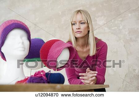 Stock Image - woman with self-made hats. Fotosearch