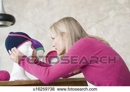 Stock Photo - woman with self-made hats. Fotosearch