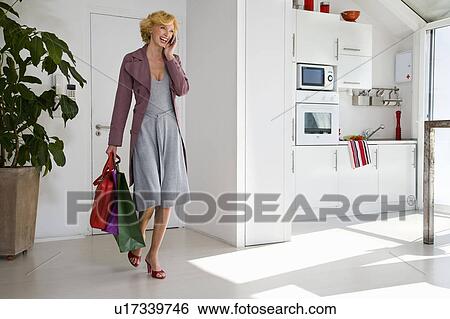 Stock Photograph - Woman with shopping bags. Fotosearch