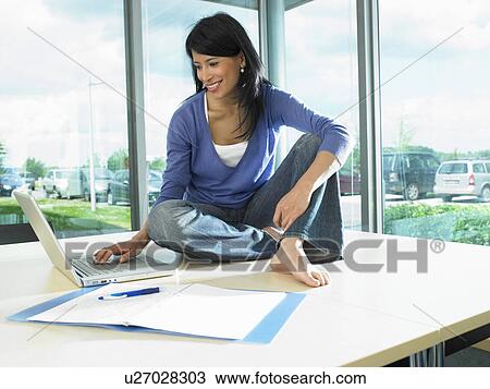Woman working on her desk View Large Photo Image Stock Image - Woman working on her desk. Fotosearch