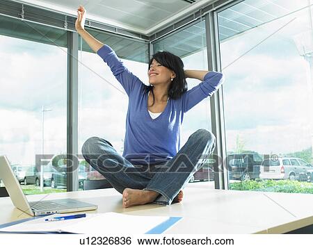 Woman working on her desk View Large Photo Image Stock Photograph - Woman working on her desk. Fotosearch