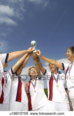 Stock Photo - women and trophy. Fotosearch