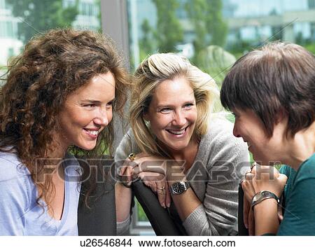 Picture - Women in a deep conversation. Fotosearch