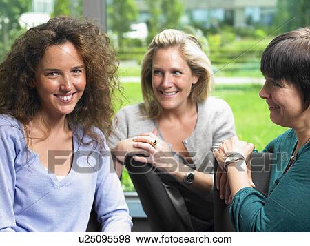 Women looking at camera, smiling View Large Photo Image Stock Photo - Women looking at camera, smiling. Fotosearch