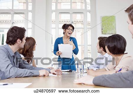 Stock Photo - Women talking at conference table. Fotosearch