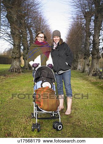 Stock Photo - women walking baby in country. Fotosearch