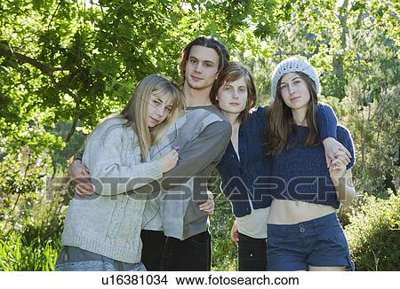 Picture - Young adults with arms around each other. Fotosearch