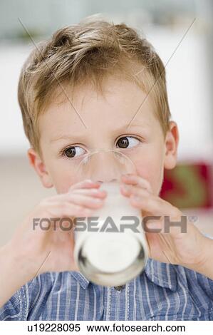 Stock Photography - young boy drinking glass of milk. Fotosearch