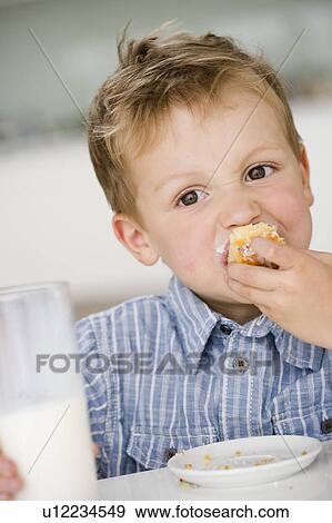 young boy eating sweet dumpling View Large Photo Image Stock Photo - young boy eating sweet dumpling. Fotosearch