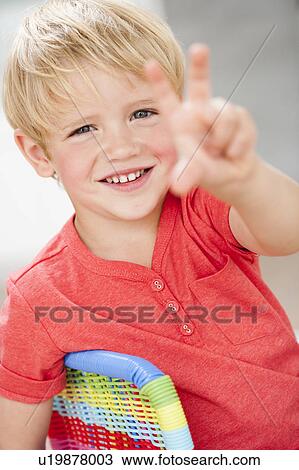 young boy holding up three fingers View Large Photo Image Stock Image - young boy holding up three fingers. Fotosearch