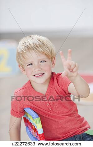 Stock Image - young boy holding up three fingers. Fotosearch