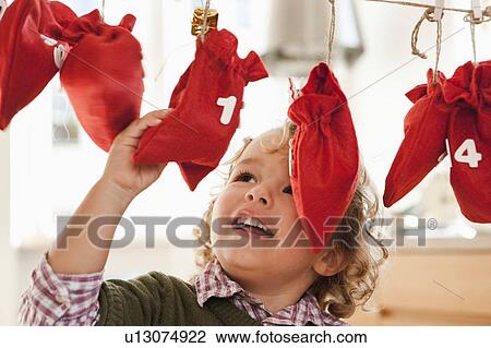 Young boy inspecting christmas sacks View Large Photo Image Stock Image - Young boy inspecting christmas sacks. Fotosearch
