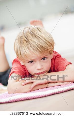 young boy lying prone on floor View Large Photo Image Stock Image - young boy lying prone on floor. Fotosearch