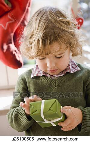 Young boy opening christmas present View Large Photo Image Stock Photography - Young boy opening christmas present. Fotosearch