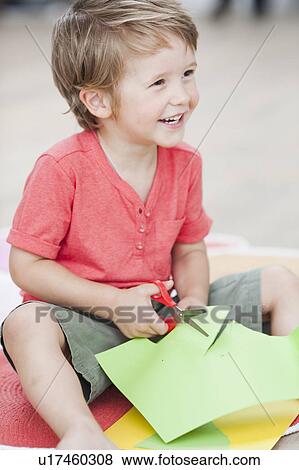 young boy playing paper and scissors View Large Photo Image Stock Photo - young boy playing paper and scissors. Fotosearch