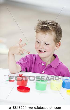 Picture - young boy playing with colours. Fotosearch