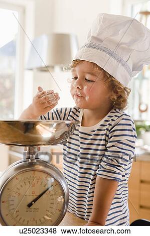 Stock Photo - Young boy playing with flour. Fotosearch