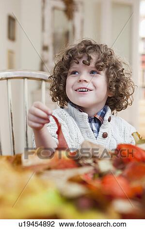 young boy playing with leaves View Large Photo Image Stock Image - young boy playing with leaves. Fotosearch