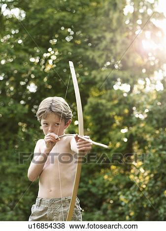 Stock Photo - Young boy plays with bow and arrow. Fotosearch