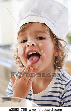 Young boy tasting dough View Large Photo Image Stock Photograph - Young boy tasting dough. Fotosearch