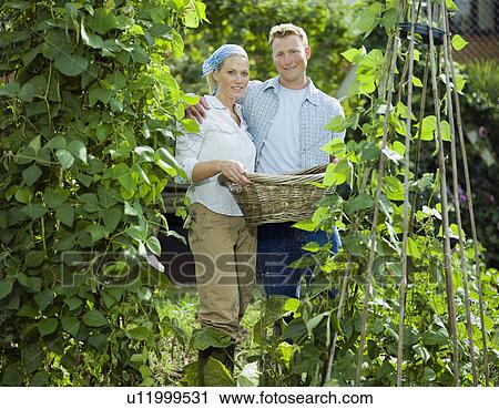 Young couple between bean plants View Large Photo Image Stock Image - Young couple between bean plants. Fotosearch