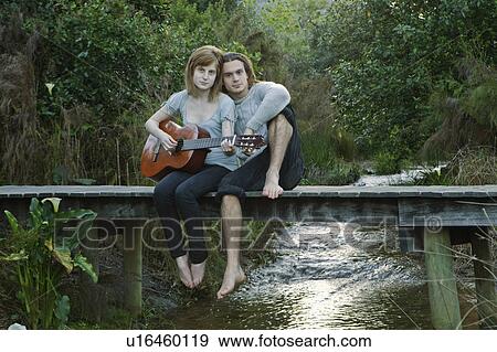 Young couple playing guitar View Large Photo Image Stock Photo - Young couple playing guitar. Fotosearch