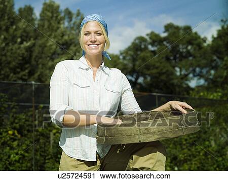 Stock Image - Young female holding a sieve. Fotosearch