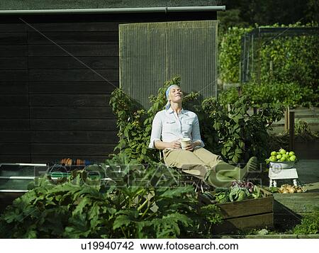 Young female relaxing in the sun View Large Photo Image Stock Image - Young female relaxing in the sun. Fotosearch