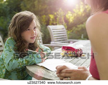 Young girl and mother chatting in garden View Large Photo Image Stock Image - Young girl and mother chatting in garden. Fotosearch