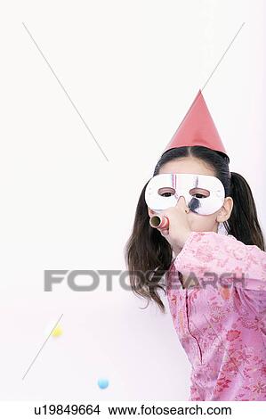 Picture - young girl blowing in a blowpipe. Fotosearch