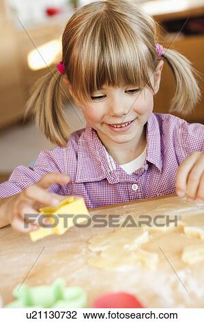young girl cutting cookies View Large Photo Image Stock Image - young girl cutting cookies. Fotosearch