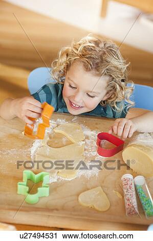 young girl cutting cookies View Large Photo Image Stock Image - young girl cutting cookies. Fotosearch