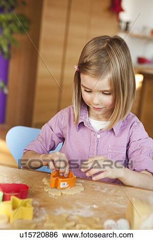 young girl cutting cookies View Large Photo Image Stock Photograph - young girl cutting cookies. Fotosearch
