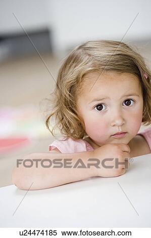 Stock Photography - young girl frowning at viewer. Fotosearch