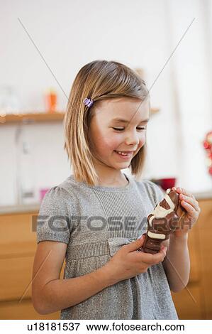 young girl holding chocolate santa claus View Large Photo Image Stock Photo - young girl holding chocolate santa claus. Fotosearch