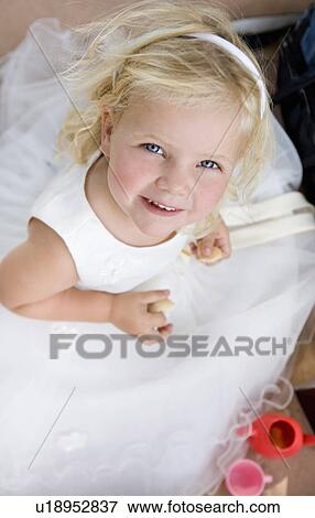Stock Photo - young girl in white dress portrait. Fotosearch